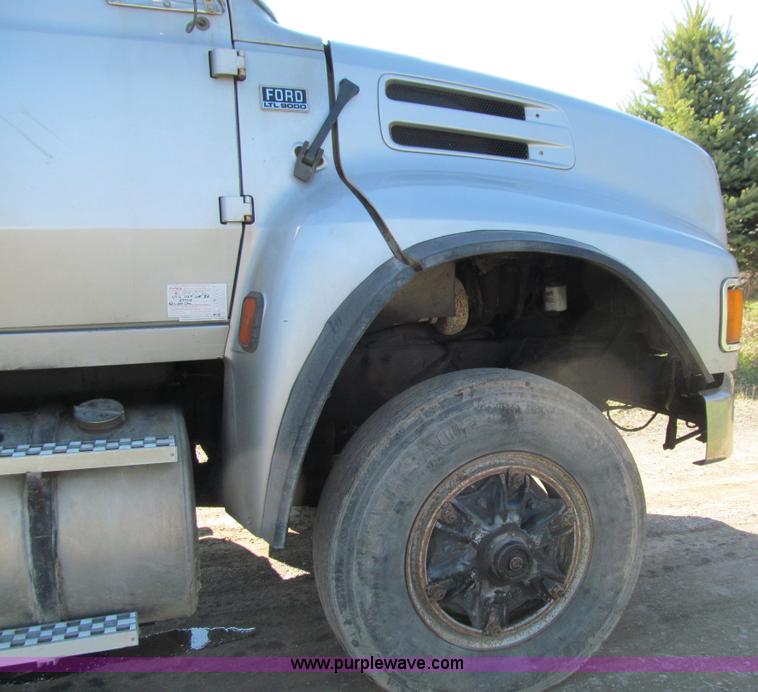 image for item E4718 1993 Ford LTL9000 tri axle semi truck