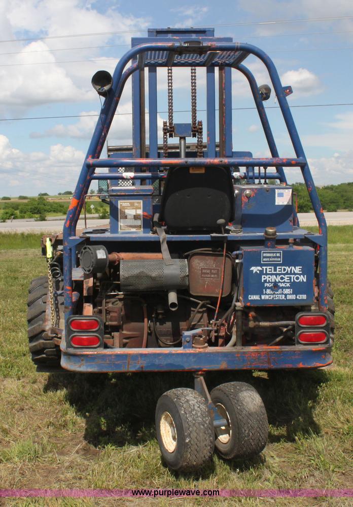 image for item I7396 2006 Chevrolet C8500 flatbed truck with forklift