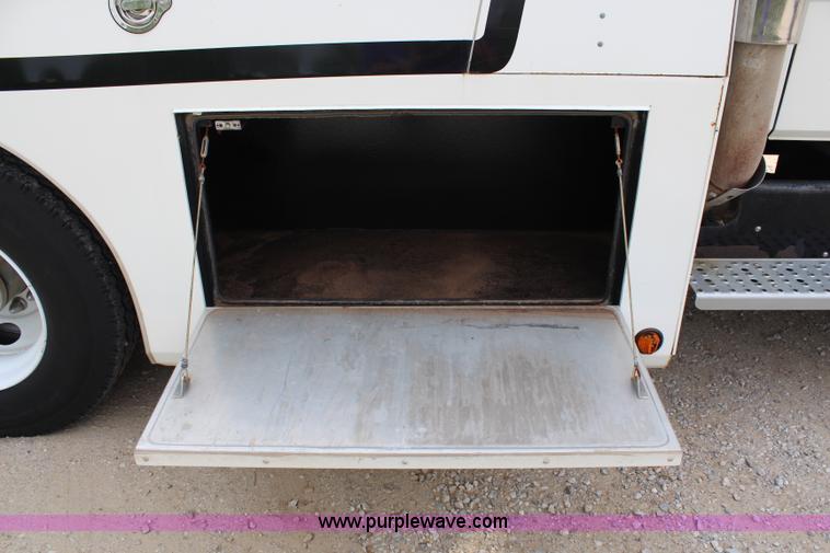 image for item H2715 2002 Freightliner FL70 Crew Cab flatbed truck