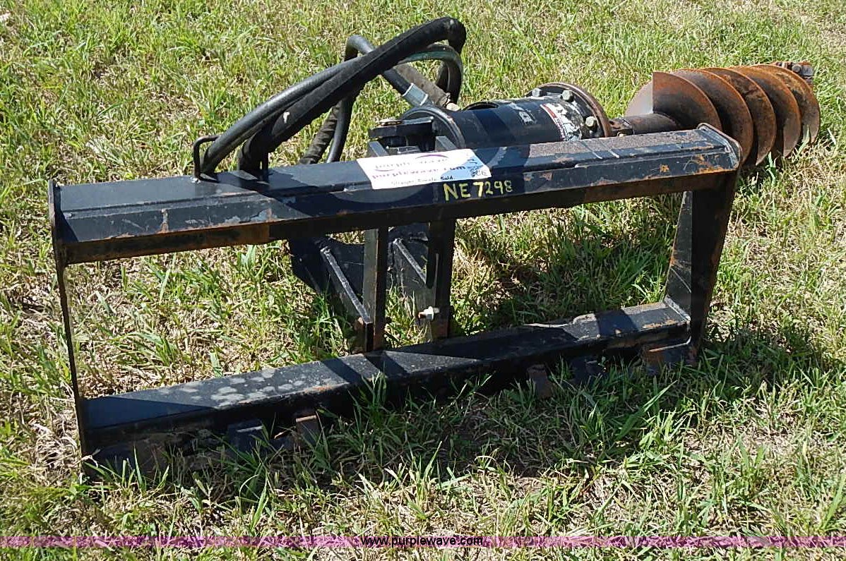 Danuser hydraulic post hole digger skid steer attachment in Blue Rapids