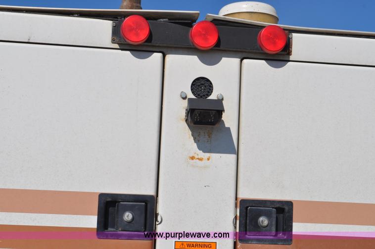 image for item F2050 1999 GMC T7500 Elgin street sweeper