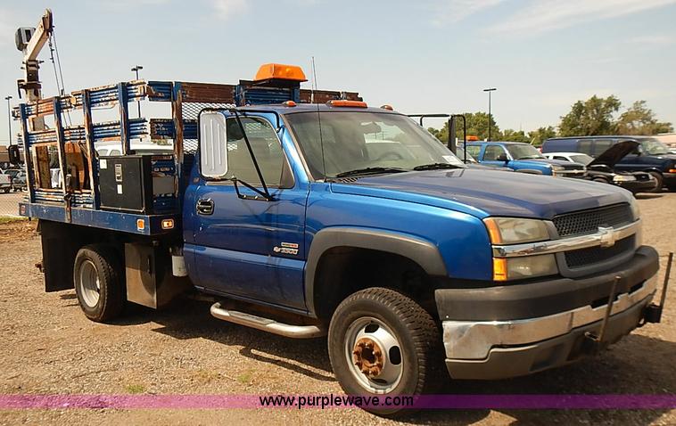 image for item E7779 2003 Chevrolet Silverado 3500 stake body flatbed truck with crane
