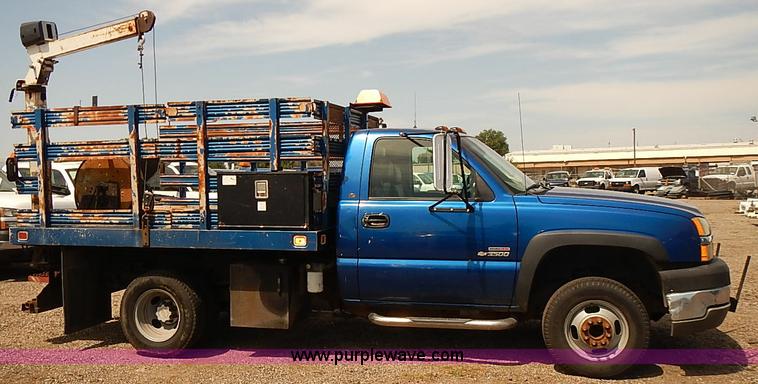 image for item E7779 2003 Chevrolet Silverado 3500 stake body flatbed truck with crane