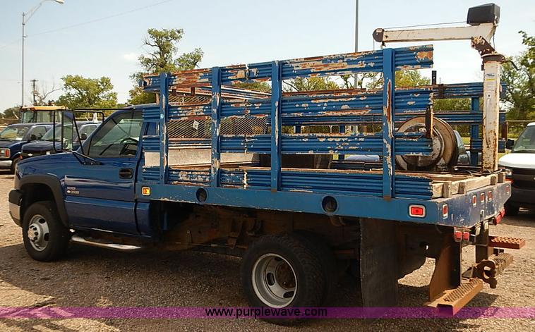 image for item E7779 2003 Chevrolet Silverado 3500 stake body flatbed truck with crane