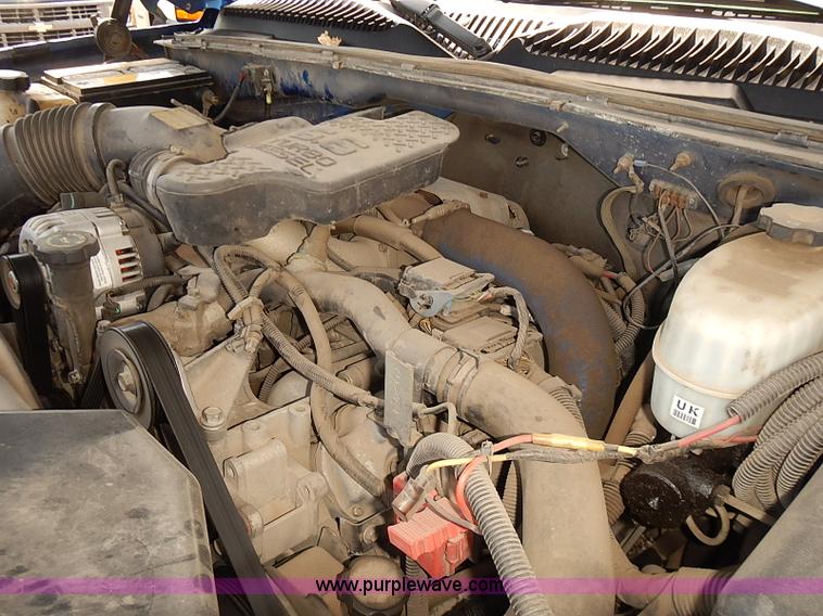 image for item E7779 2003 Chevrolet Silverado 3500 stake body flatbed truck with crane