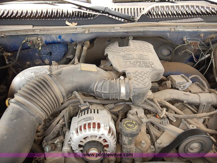 image for item E7779 2003 Chevrolet Silverado 3500 stake body flatbed truck with crane