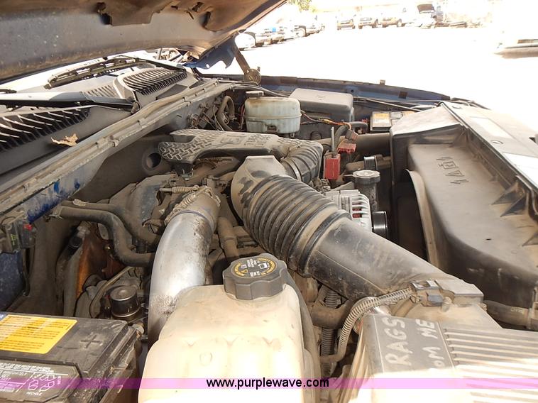 image for item E7779 2003 Chevrolet Silverado 3500 stake body flatbed truck with crane