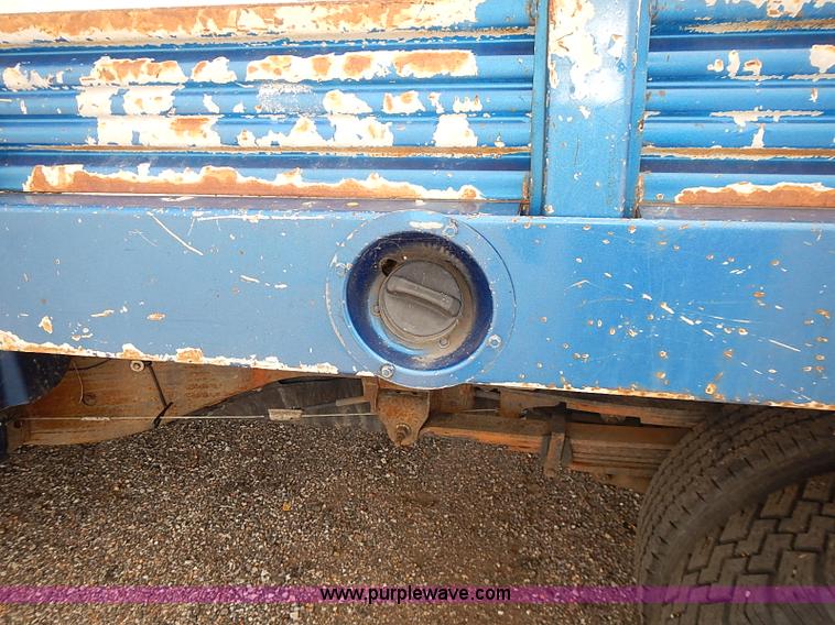 image for item E7779 2003 Chevrolet Silverado 3500 stake body flatbed truck with crane