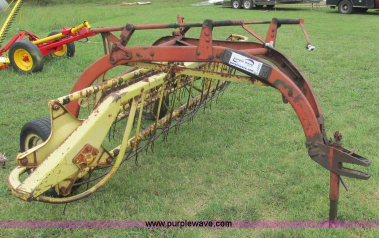 image for item J2422 New Holland 256 roll bar hay rake