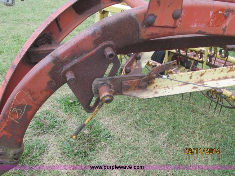 image for item J2422 New Holland 256 roll bar hay rake