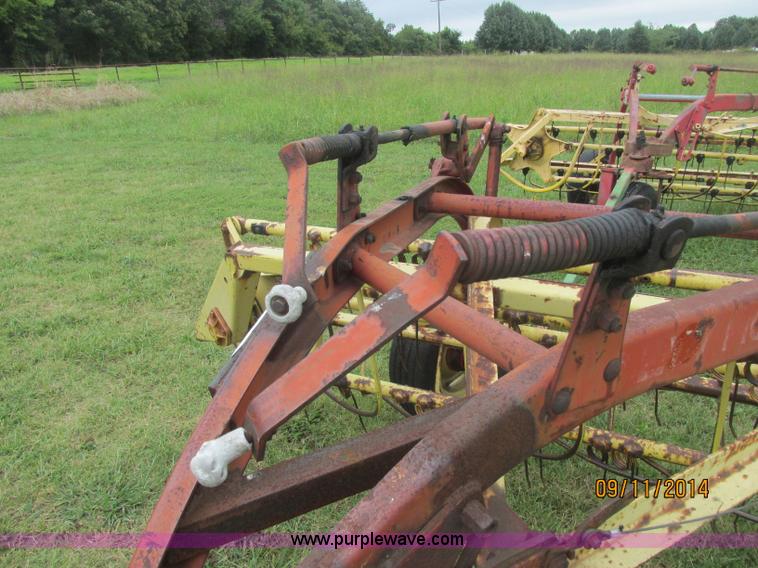 image for item J2422 New Holland 256 roll bar hay rake