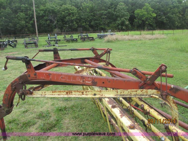 image for item J2422 New Holland 256 roll bar hay rake