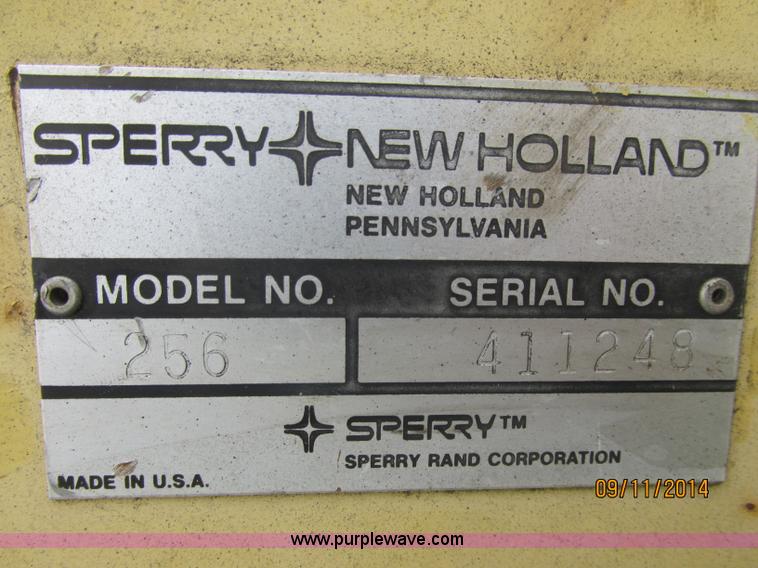 image for item J2422 New Holland 256 roll bar hay rake