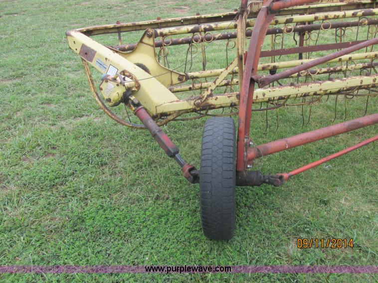 image for item J2422 New Holland 256 roll bar hay rake