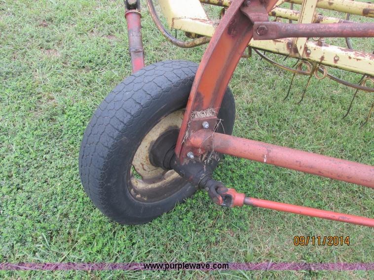 image for item J2422 New Holland 256 roll bar hay rake