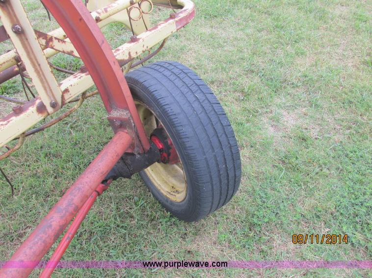 image for item J2422 New Holland 256 roll bar hay rake