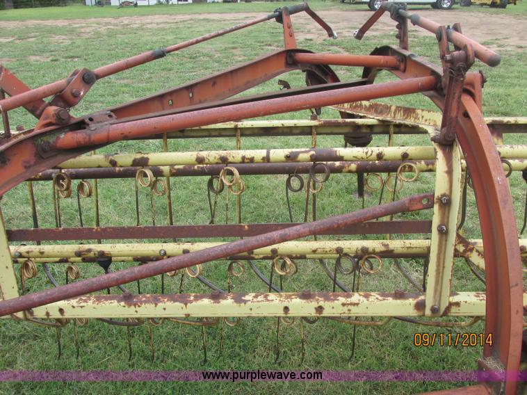 image for item J2422 New Holland 256 roll bar hay rake