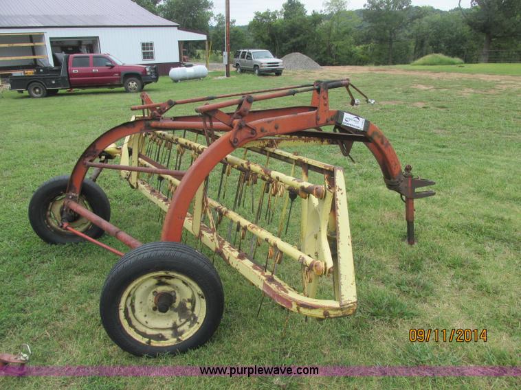 image for item J2422 New Holland 256 roll bar hay rake