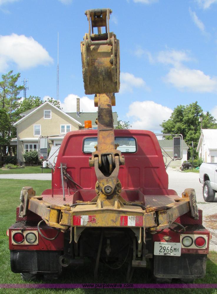 image for item G9097 1984 Chevrolet 60 flatbed truck with backhoe attachment