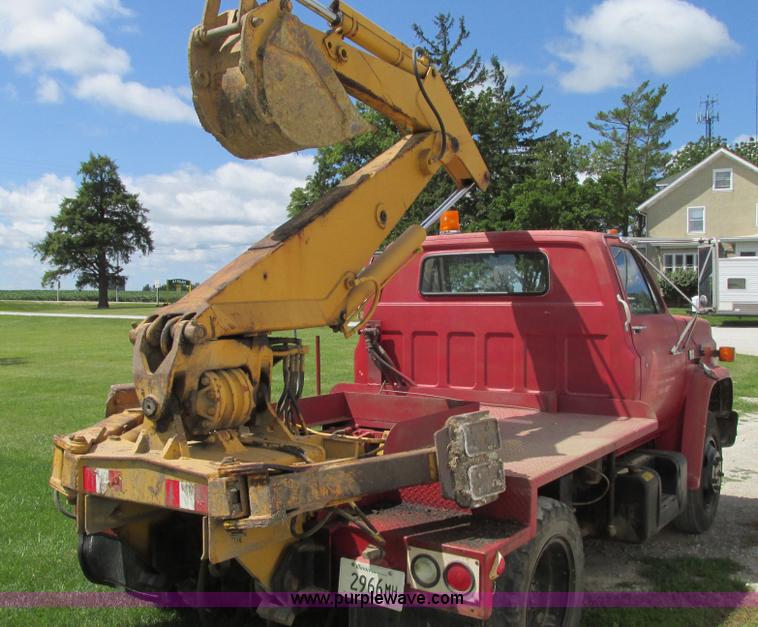 image for item G9097 1984 Chevrolet 60 flatbed truck with backhoe attachment