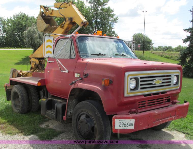 image for item G9097 1984 Chevrolet 60 flatbed truck with backhoe attachment