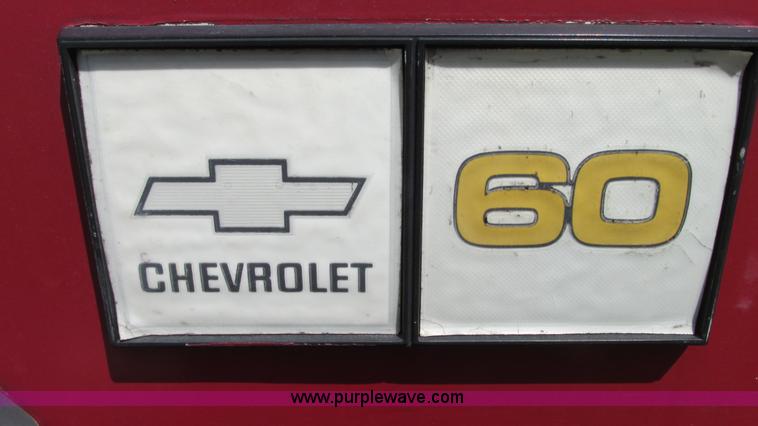 image for item G9097 1984 Chevrolet 60 flatbed truck with backhoe attachment