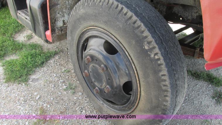 image for item G9097 1984 Chevrolet 60 flatbed truck with backhoe attachment