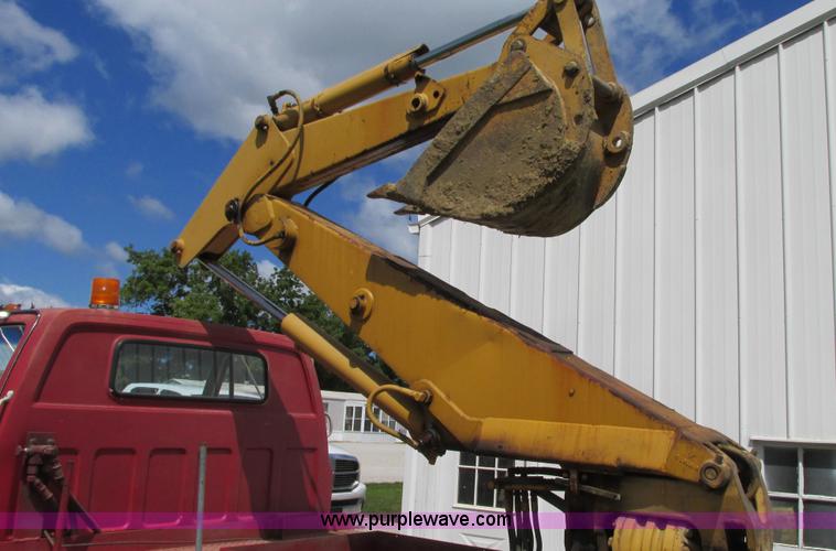 image for item G9097 1984 Chevrolet 60 flatbed truck with backhoe attachment