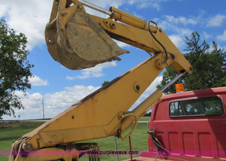 image for item G9097 1984 Chevrolet 60 flatbed truck with backhoe attachment