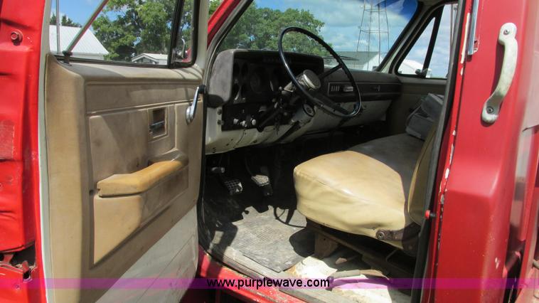 image for item G9097 1984 Chevrolet 60 flatbed truck with backhoe attachment