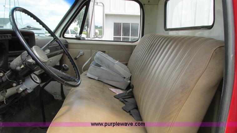 image for item G9097 1984 Chevrolet 60 flatbed truck with backhoe attachment