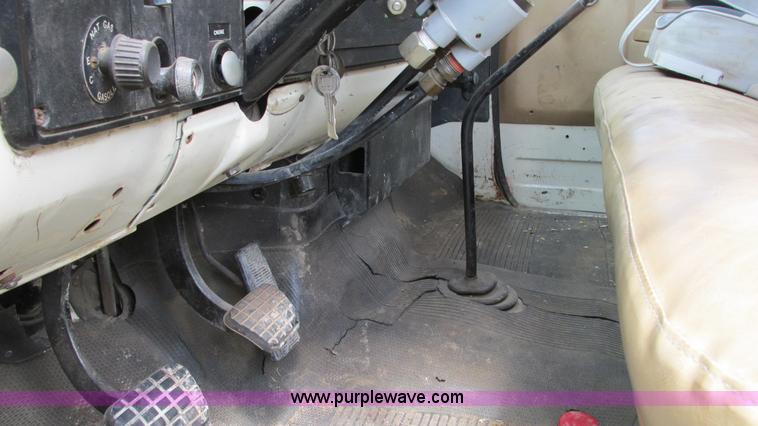 image for item G9097 1984 Chevrolet 60 flatbed truck with backhoe attachment