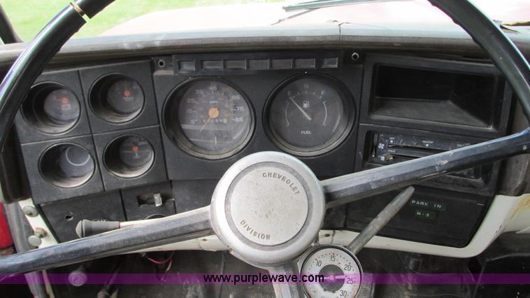 image for item G9097 1984 Chevrolet 60 flatbed truck with backhoe attachment