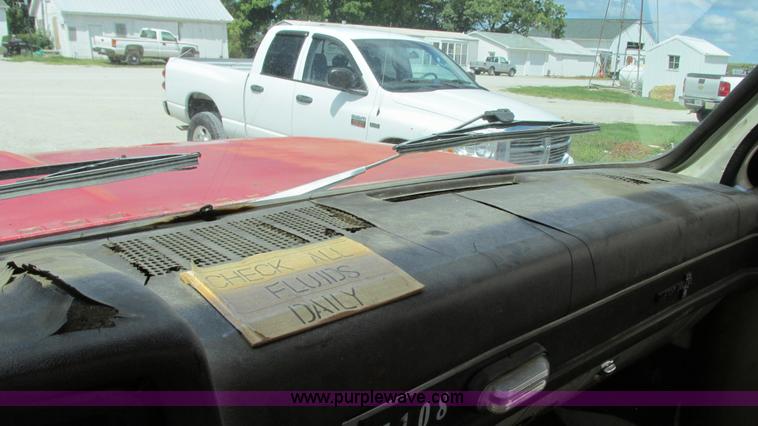 image for item G9097 1984 Chevrolet 60 flatbed truck with backhoe attachment