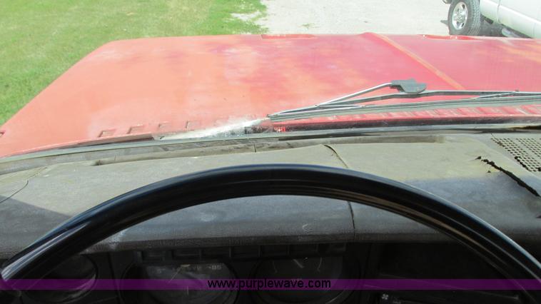 image for item G9097 1984 Chevrolet 60 flatbed truck with backhoe attachment