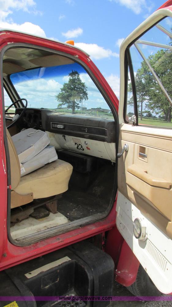 image for item G9097 1984 Chevrolet 60 flatbed truck with backhoe attachment