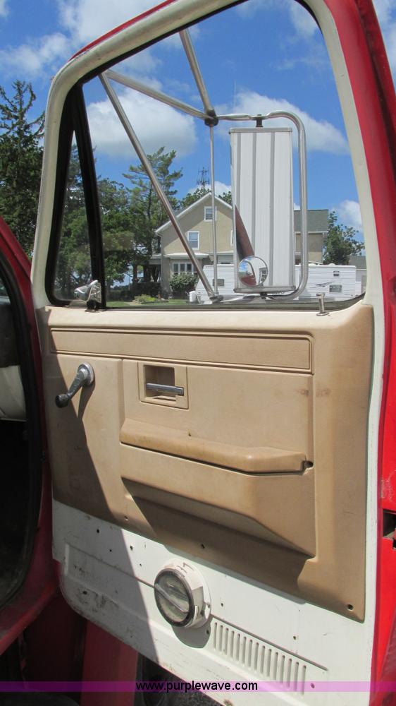 image for item G9097 1984 Chevrolet 60 flatbed truck with backhoe attachment