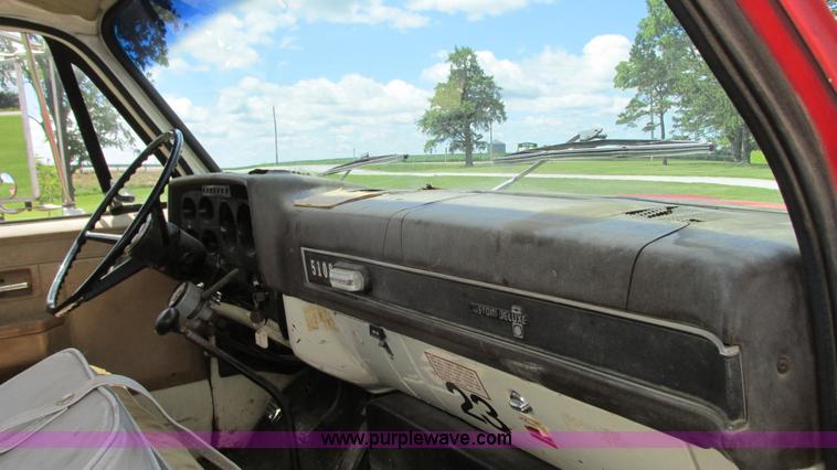 image for item G9097 1984 Chevrolet 60 flatbed truck with backhoe attachment