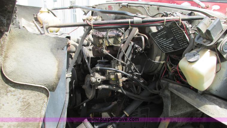 image for item G9097 1984 Chevrolet 60 flatbed truck with backhoe attachment