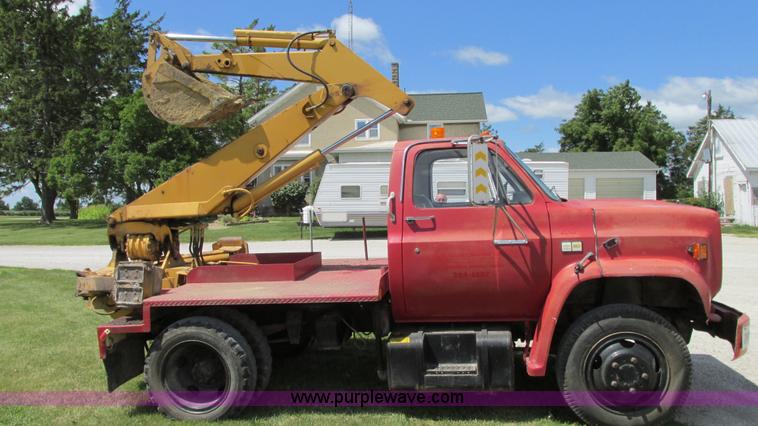 image for item G9097 1984 Chevrolet 60 flatbed truck with backhoe attachment
