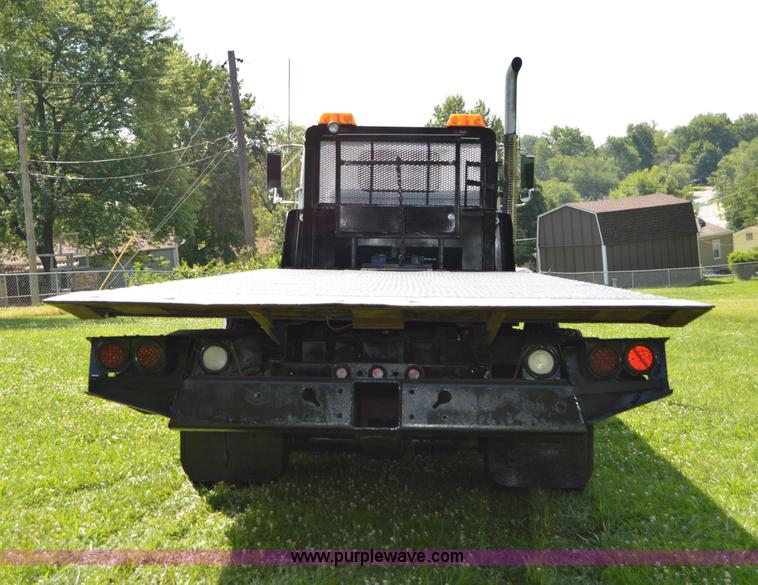 image for item H2873 1999 Volvo WG rollback truck