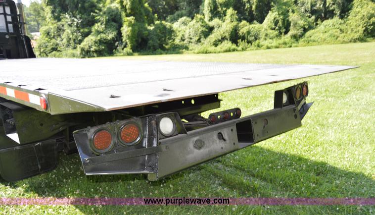 image for item H2873 1999 Volvo WG rollback truck