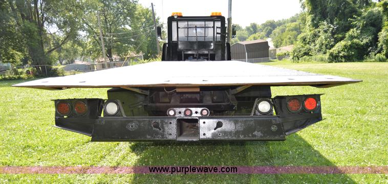 image for item H2873 1999 Volvo WG rollback truck