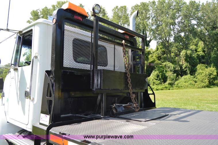 image for item H2873 1999 Volvo WG rollback truck