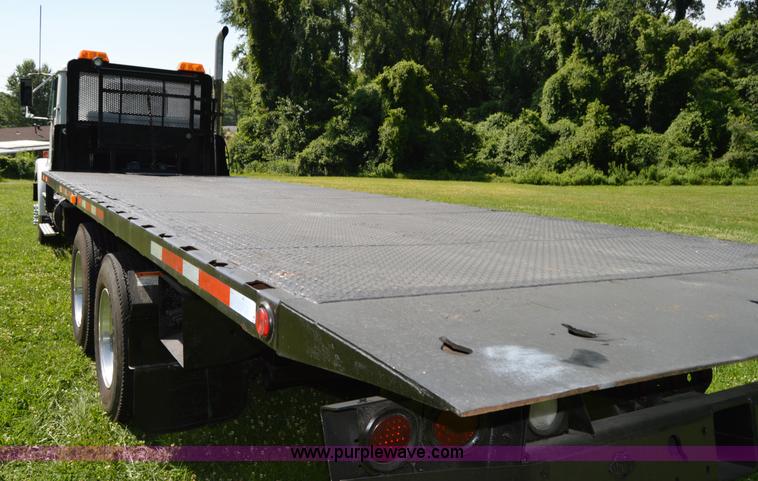 image for item H2873 1999 Volvo WG rollback truck