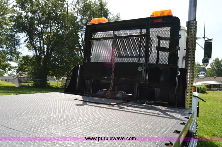 image for item H2873 1999 Volvo WG rollback truck