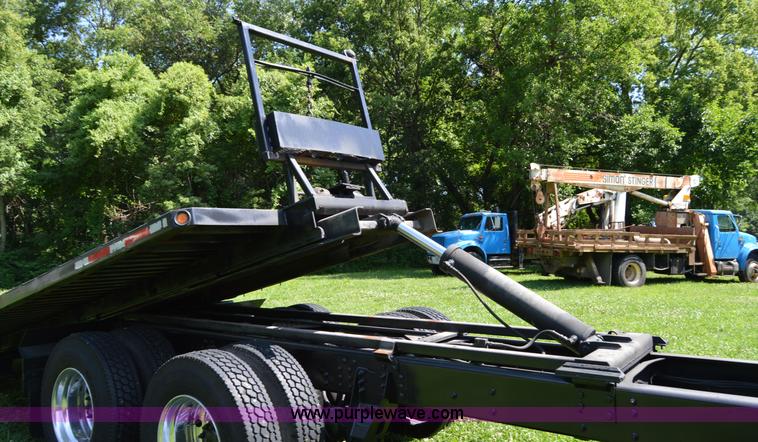 image for item H2873 1999 Volvo WG rollback truck