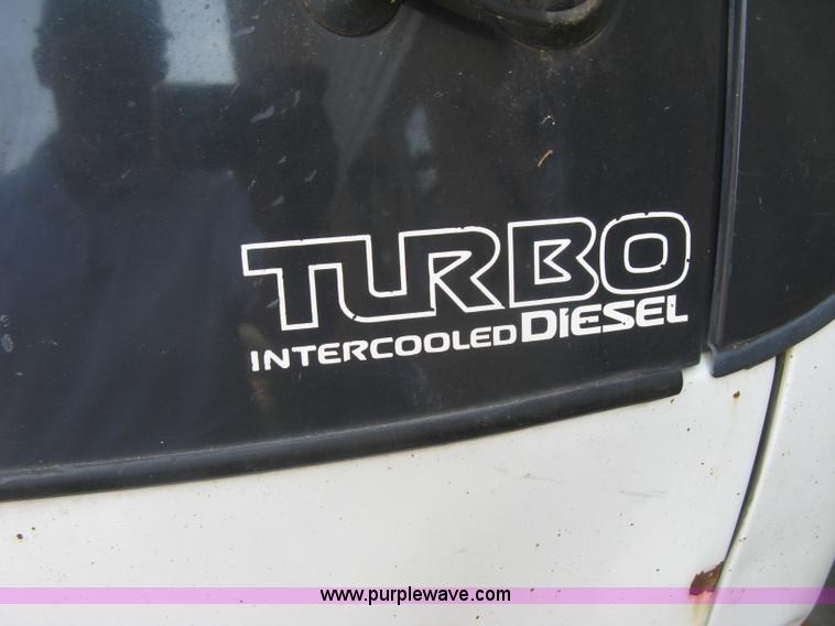 image for item E7965 2001 Isuzu NQR flatbed dump truck