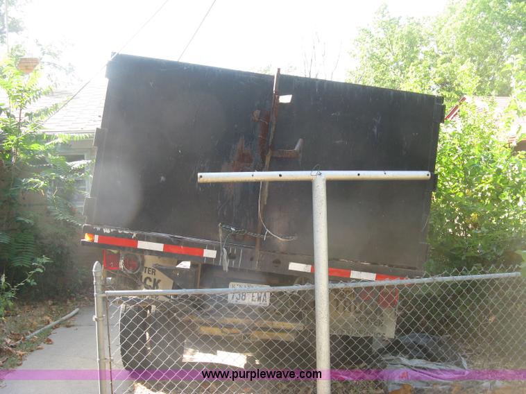 image for item E7965 2001 Isuzu NQR flatbed dump truck