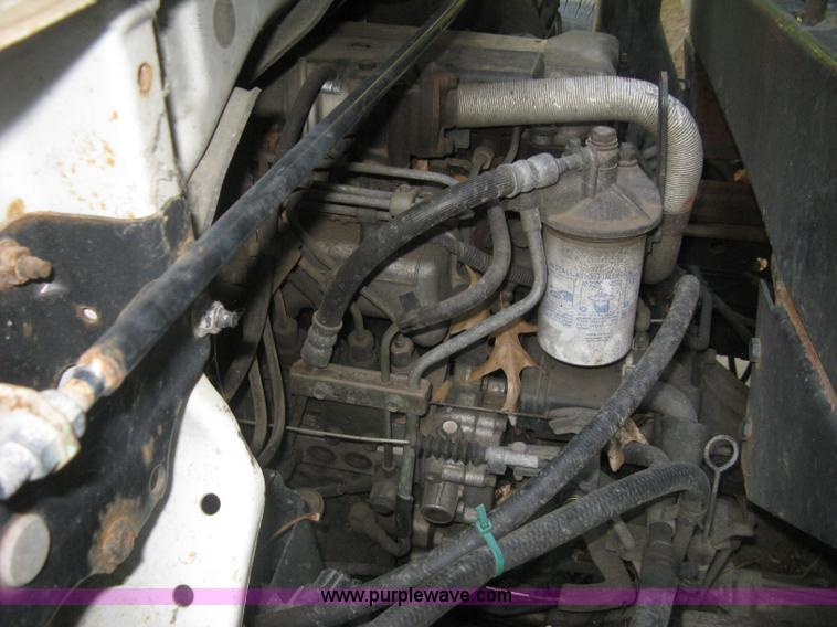 image for item E7965 2001 Isuzu NQR flatbed dump truck